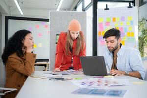 Multiethnic young business people working together in modern office, Collaborate to designing an application for use on the internet network. photo