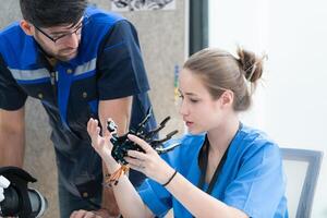 Engineers, doctors and physical therapists brainstorm ideas to design a robot with arm and hand organs, To be utilized for additional testing on patients. photo