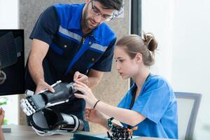 Engineers, doctors and physical therapists brainstorm ideas to design a robot with arm and hand organs, To be utilized for additional testing on patients. photo