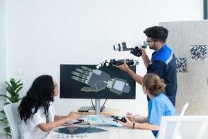 Engineers, doctors and physical therapists brainstorm ideas to design a robot with arm and hand organs, To be utilized for additional testing on patients. photo