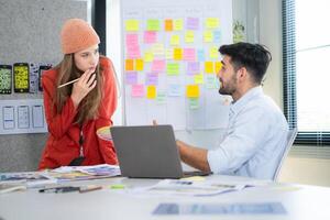 Multiethnic young business people working together in modern office, Collaborate to designing an application for use on the internet network. photo