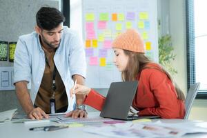 Multiethnic young business people working together in modern office, Collaborate to designing an application for use on the internet network. photo