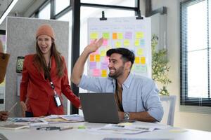 Multiethnic young business people working together in modern office, Collaborate to designing an application for use on the internet network. photo