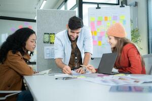 Multiethnic young business people working together in modern office, Collaborate to designing an application for use on the internet network. photo