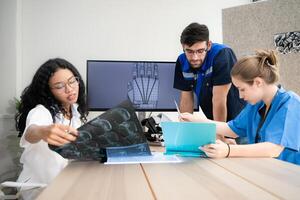 Engineers, doctors and physical therapists brainstorm ideas to design a robot with arm and hand organs, To be utilized for additional testing on patients. photo