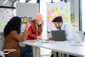 Multiethnic young business people working together in modern office, Collaborate to designing an application for use on the internet network. photo