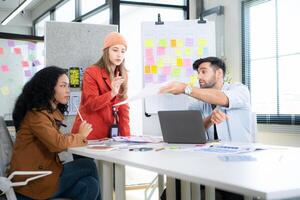 Multiethnic young business people working together in modern office, Collaborate to designing an application for use on the internet network. photo