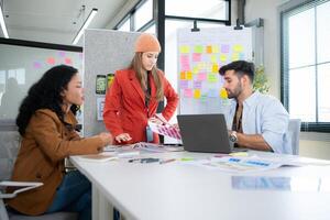 Multiethnic young business people working together in modern office, Collaborate to designing an application for use on the internet network. photo