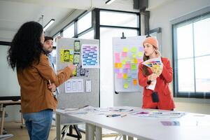 Multiethnic young business people working together in modern office, Collaborate to designing an application for use on the internet network. photo