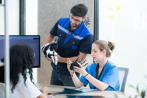 Engineers, doctors and physical therapists brainstorm ideas to design a robot with arm and hand organs, To be utilized for additional testing on patients. photo