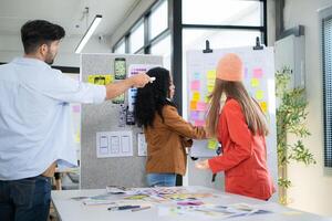 Multiethnic young business people working together in modern office, Collaborate to designing an application for use on the internet network. photo
