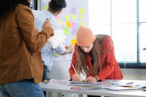 Multiethnic young business people working together in modern office, Collaborate to designing an application for use on the internet network. photo