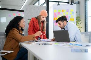 Multiethnic young business people working together in modern office, Collaborate to designing an application for use on the internet network. photo