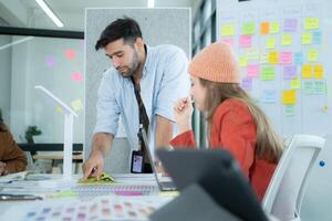 Multiethnic young business people working together in modern office, Collaborate to designing an application for use on the internet network. photo
