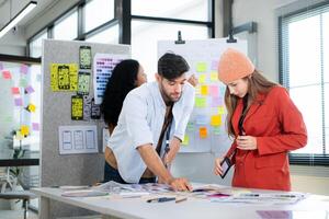 Multiethnic young business people working together in modern office, Collaborate to designing an application for use on the internet network. photo