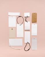 White price labels, blank tags with different shapes and sizes on a beige background. photo
