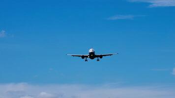 Commercial passenger airplane flying in the amazing blue sky and dark clouds. Travel by air transport. Travel background advertising. Jet flying at flight level high in the sky above the clouds video