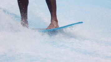 Barefoot surfer balancing on a surfboard. Water sports activity. Instructor demonstrating how to stand up on surfboard. The concept of practice and perseverance before it succeeds. Banner, copy space video