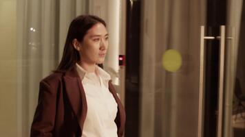 Classy model walking along glass walls building video