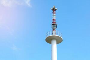 Flood warning tower on the background of a bright daytime sky. soft and selective focus. photo