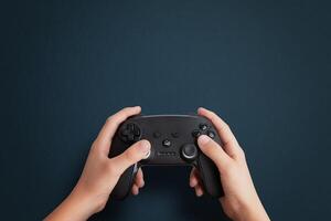 Top view of a hand holding a gamepad on a blue desk, flat lay composition with clean space for promotional text, ideal for gaming and tech branding photo