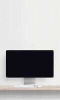 Desktop monitor with a blank screen on a desk featuring a keyboard and mouse, perfect for mockup presentations of websites photo