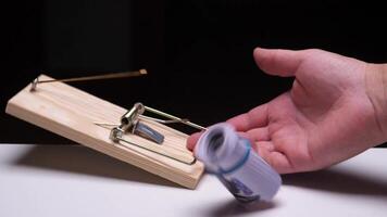 A man falls into a trap with money bait. Mousetrap with money bait video
