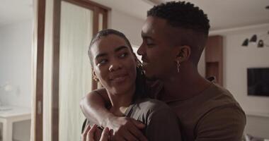Diverse couple hugging during lunch preparation video