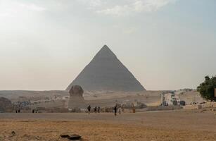 Egyptian Pyramid Of Khufu Cheops With The Sphinx In The Background photo
