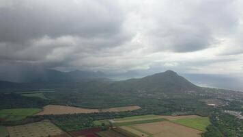 top view of rural fields and rain in the distance, Mauritius video