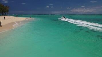 Mauritius. view from the height of the beach and the boat cutting the waves of the ocean video