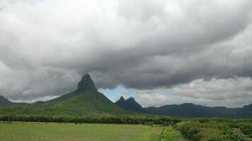 shooting from top to bottom the peaks of mountains and jungles of Mauritius, the sky in clouds video