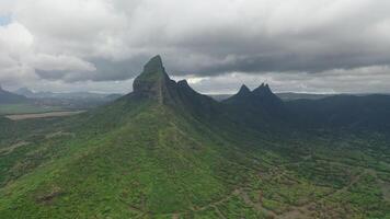 shooting from top to bottom the peaks of mountains and jungles of Mauritius, the sky in clouds video