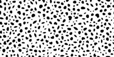 Seamless dotted pattern. Black specks and spots on a white background. Texture is grainy and large. vector