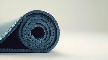 Rolled Up Yoga Mat Isolated on White Background for Wellness Practices photo
