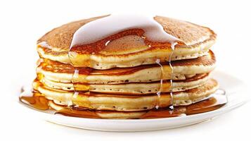 Stack of Fluffy Pancakes Drizzled with Maple Syrup on White Plate photo
