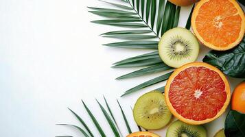 Fresh Tropical Fruits and Green Leaves on Clean White Background photo