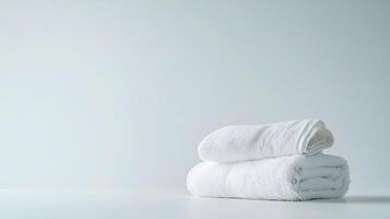 Neatly Folded White Towels on Crisp White Background for Spa Use photo