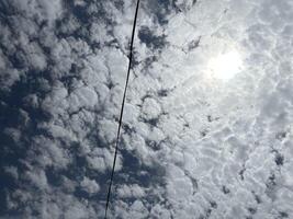 A street sign with a kite flying in the sky photo