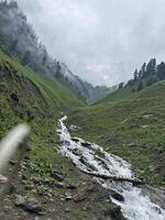 A stream running through a mountain valley photo