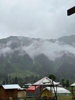 A view of tents and mountains in the background photo