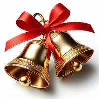 Two shiny golden bells tied with a red ribbon, isolated on a white background photo