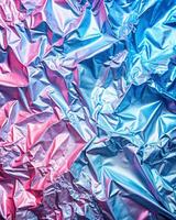 A close up of a shiny blue and pink crumpled paper photo