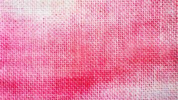 A close up of a pink fabric with white spots photo
