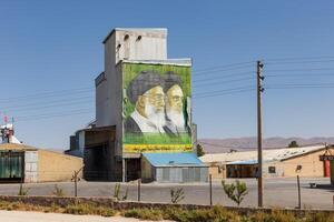 Beyg Nazar, Razavi Khorasan Province, Iran - September 12, 2024 - Mural of leaders displayed on industrial building in rural area. Iran's Industrial Landscape photo