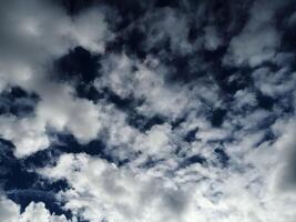 Dynamic Cloud Formation Against Dark Blue Sky photo