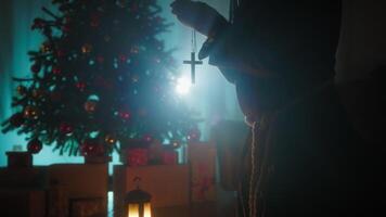 Man Prays In Silhouette In Front Of Christmas Tree At Night For Religious Peace video
