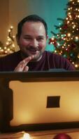 Man Makes Call With Computer In His Room Decorated For Christmas video