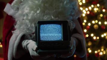 Santa Claus Holds Static Television Signal In Front Of Christmas Tree video