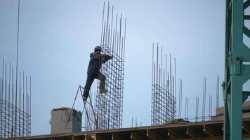 Building workers are constructing a metal framework. Construction of a residential complex video